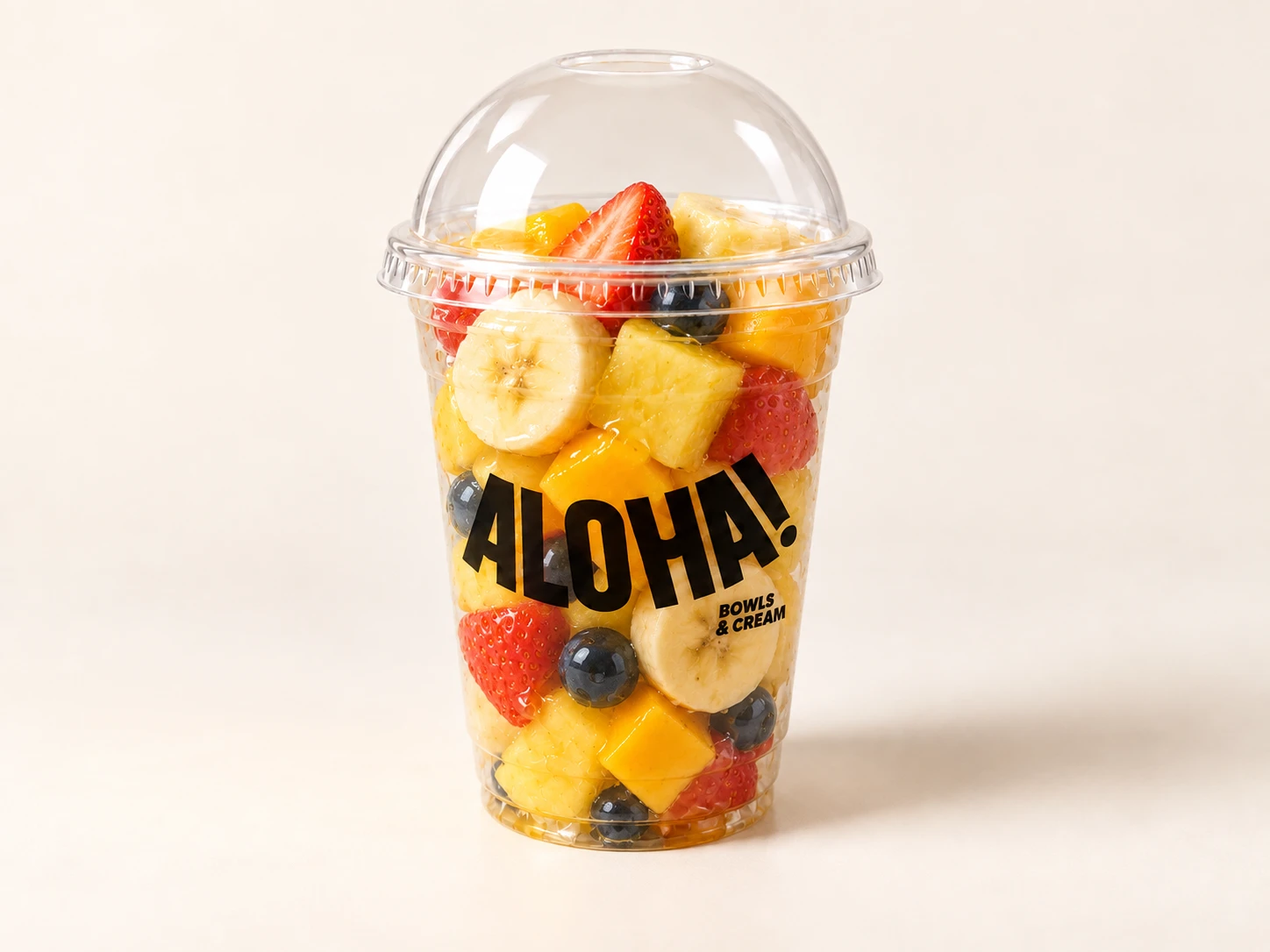 Fruit cup with pineapple, mango, banana, strawberries and blueberries